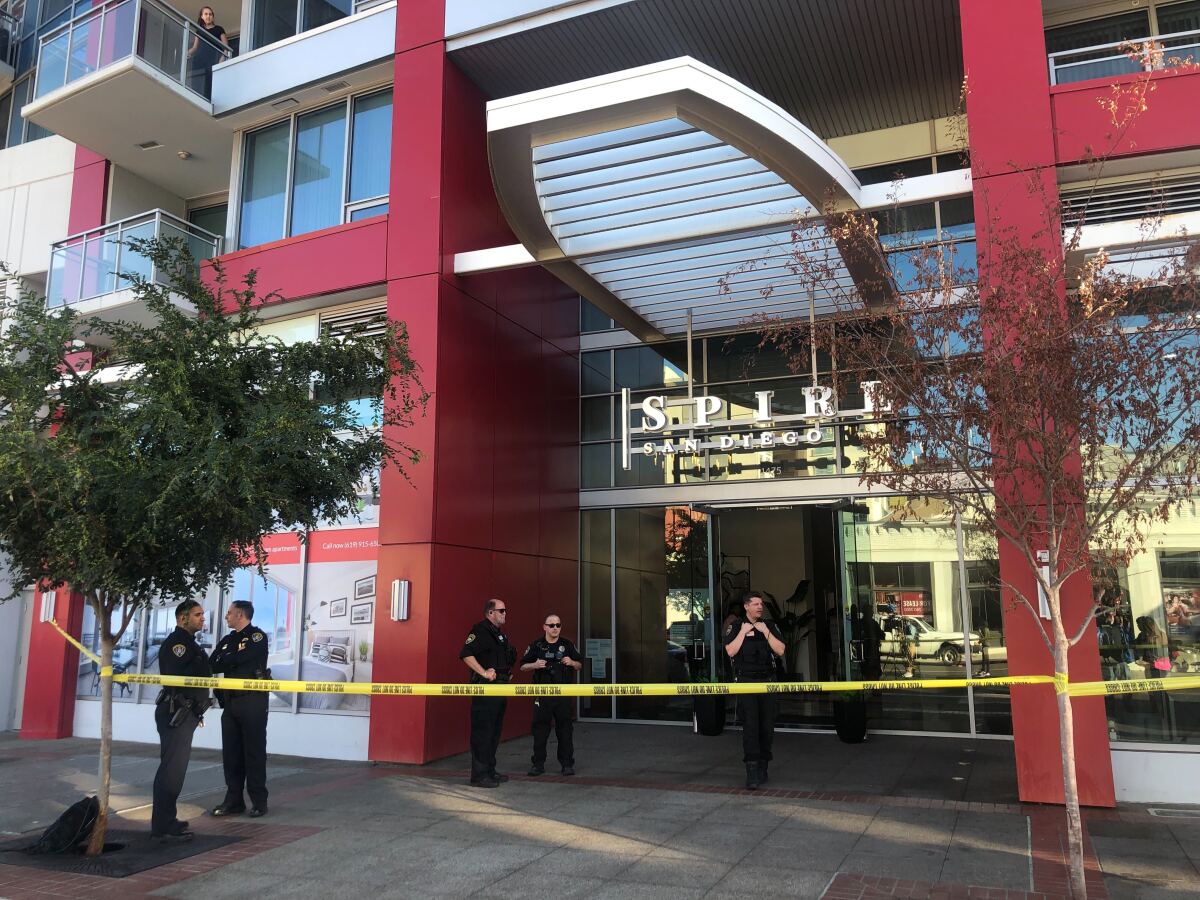 SDPD officers stand outside entrance to the Spire San Diego high-rise in the East Village, where two people were found dead.