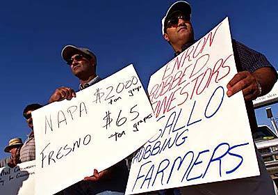 Abe Aulakh, left, and and brother Jack, two grape growers from Kerman, Calif., holding up signs in front of Gallo Winery.