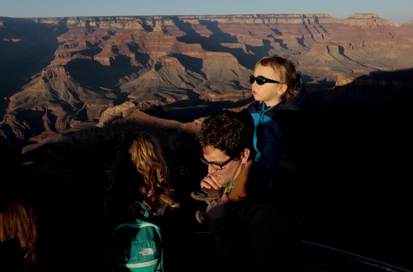 Visitors take in the view along the South Rim.