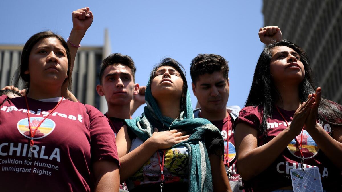 Protestors listen to speeches during a downtown L.A. rally against U.S. immigration policies.