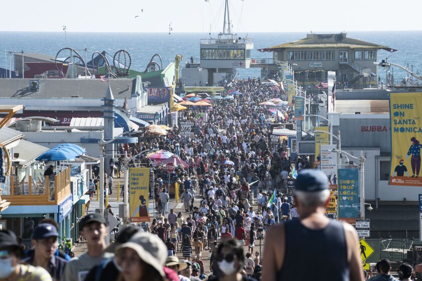 Crowds walk on the Santa Monica Pier during Independence Day celebrations on July 4, 2021 in Santa Monica. ( Nick Agro / For The Times )