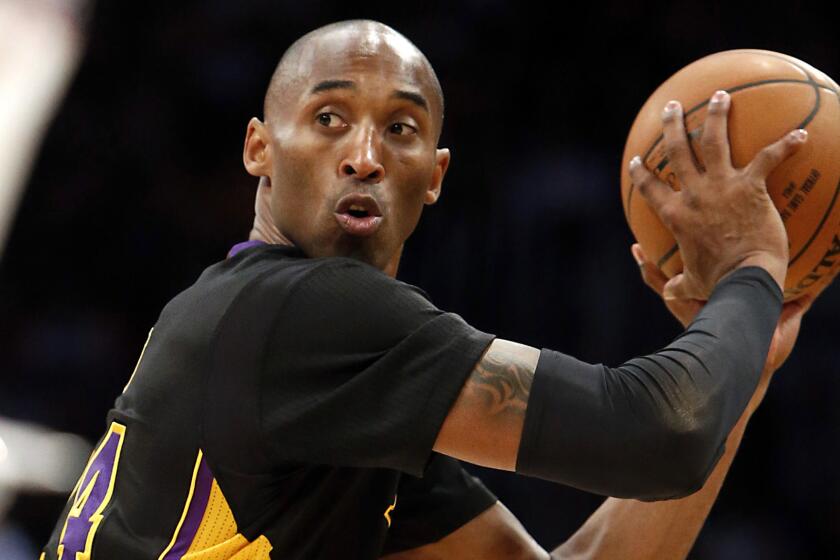 Lakers star Kobe Bryant looks to pass during a loss to the Clippers on Friday.