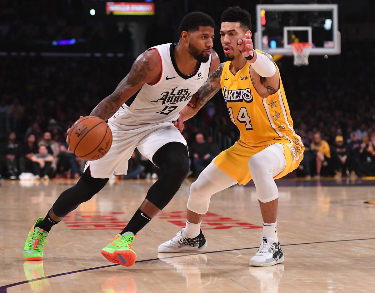 Clippers forward Paul George tries to drive past Lakers guard Danny Green during a game on Dec. 25, 2019.