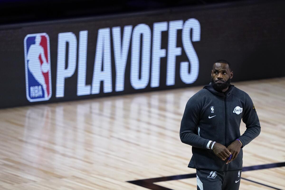 Lakers forward LeBron James walks onto the court before Tuesday's game against the Trail Blazers.