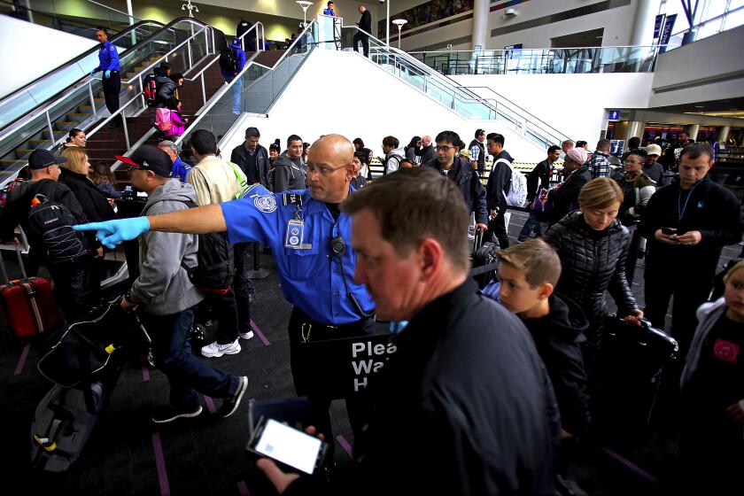 Luis Sinco  Los Angeles Times A TRANSPORTATION Security Administration agent guides travelers through a checkpoint at Los Angeles International Airport, where increased staffing and advanced technology have helped reduce wait times.