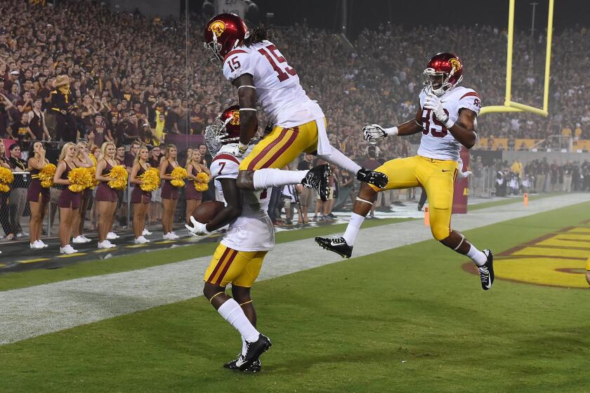 USC's Steven Mitchell Jr. (7) is joined in celebration by teammates Isaac Whitney (15) and De'Quan Hampton after his 27-yard touchdown reception in the second quarter Sept. 26 against Arizona State.