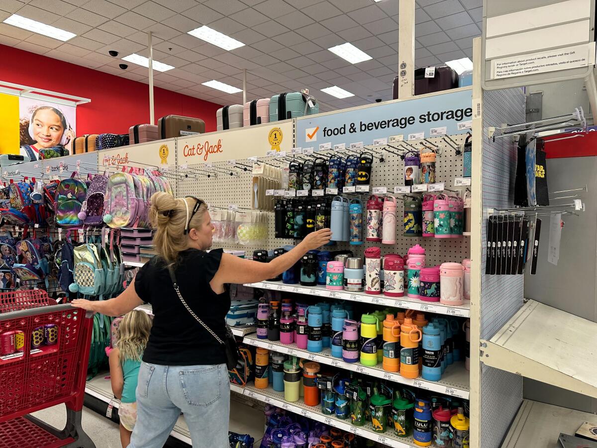 A woman reaches for a water bottle at a Target store.