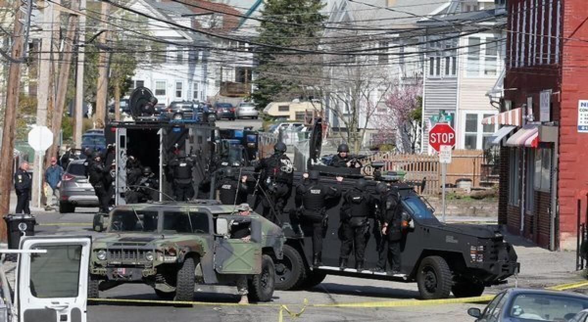 Members of a SWAT team search for 19-year-old bombing suspect Dzhokhar Tsarnaev in Watertown, Mass.