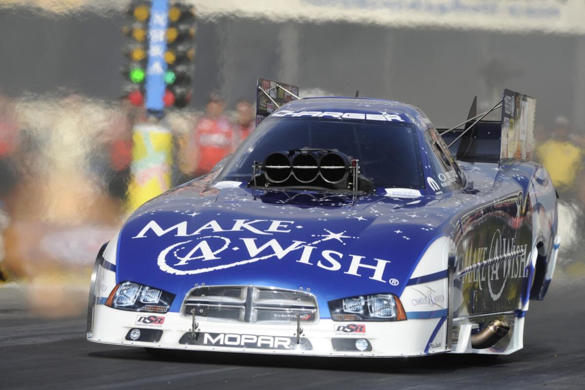 Tommy Johnson Jr. drives to the first day qualifying lead the the Auto Club NHRA Finals on Friday in Pomona.