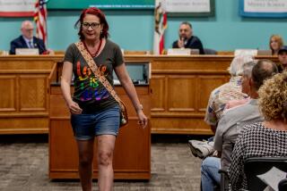 MURRIETA, CA - AUGUST 10, 2023: Parent Tracy Nusbaum, of Murrieta, mother of four children one of which is transgender, leaves the room after speaking out against the parental notification policy during the Murrieta Valley school board meeting on August 10, 2023 in Murrieta, CA. The board voted 3-2 to enact the policy which would notify parents of any transgender children in schools.(Gina Ferazzi / Los Angeles Times)