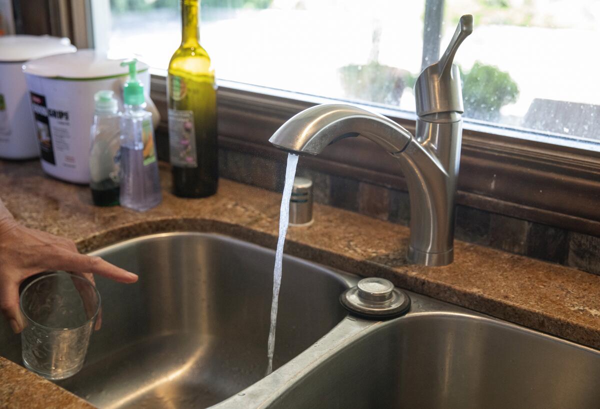 Tap water flows from a kitchen sink