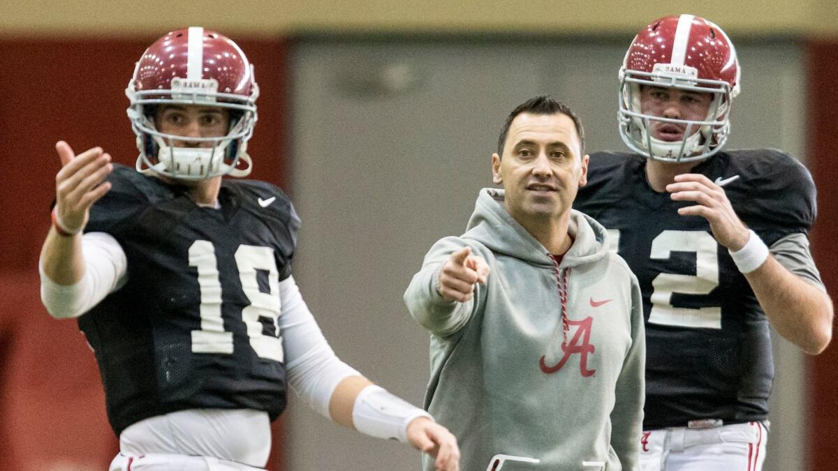 Alabama offensive coordinator Steve Sarkisian works with quarterbacks Cooper Bateman (18) and David Cornwell during practice on Jan. 4.