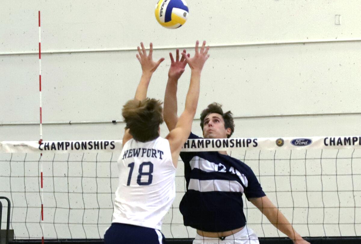 Newport Harbor's Luca Curci (18) and Loyola's Owen Loncar (24) jump for the ball for a score during the Division 1 final.