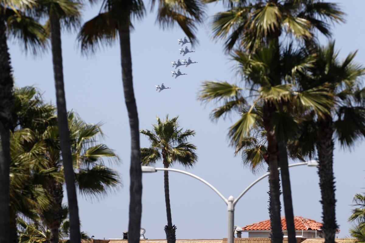 The Thunderbirds fly over Balboa Peninsula in Newport Beach on Friday as a salute California's front-line COVID-19 responders. The original flight path showed the Thunderbirds were supposed to fly along the coastline, but instead flew more inland over Balboa Peninsula.
