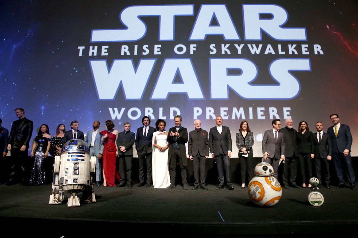 Cast and creators of 'Star Wars: The Rise of Skywalker' stand onstage before the world premiere audience in Hollywood.