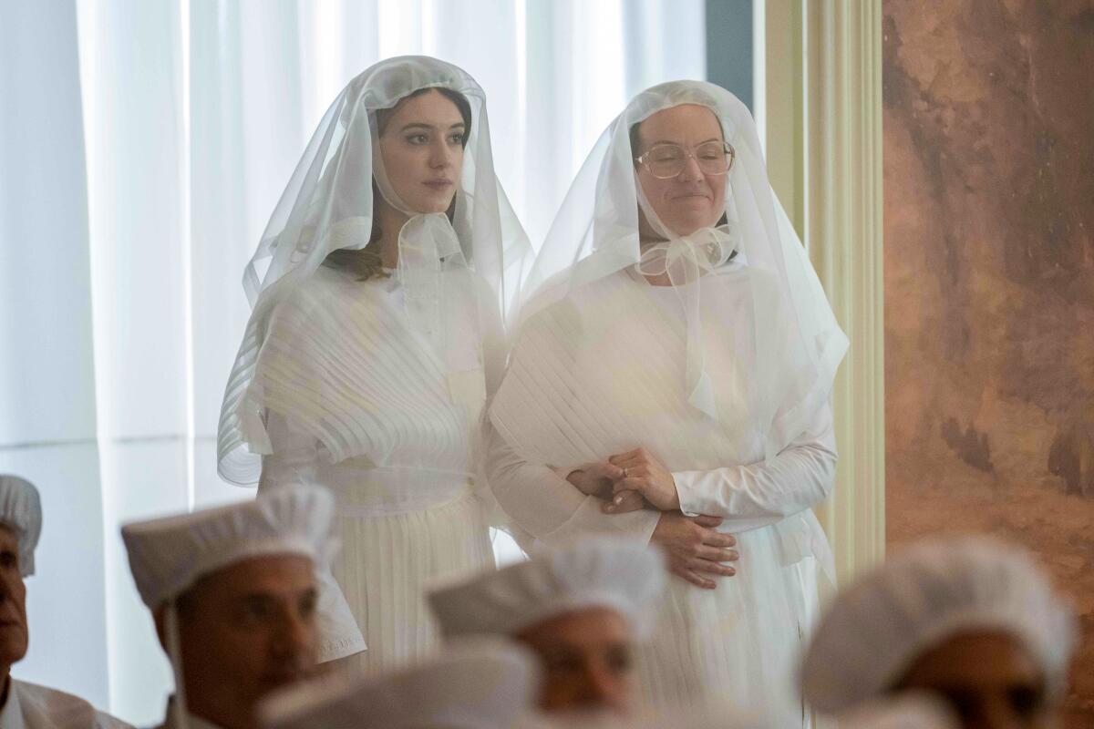 Two women in white dresses and white veils 