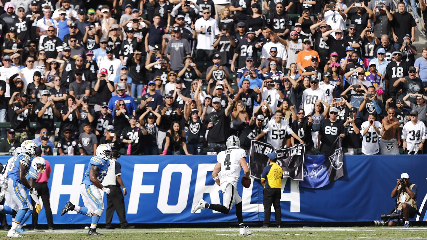 Oakland Raiders quarterback Derek Carr rolls out to throw a touchdown pass to Jordy Nelson in front of a sea of Raiders fans against the Chargers at the StubHub Center in Carson on Oct. 7, 2018. (Photo by K.C. Alfred/San Diego Union-Tribune)
