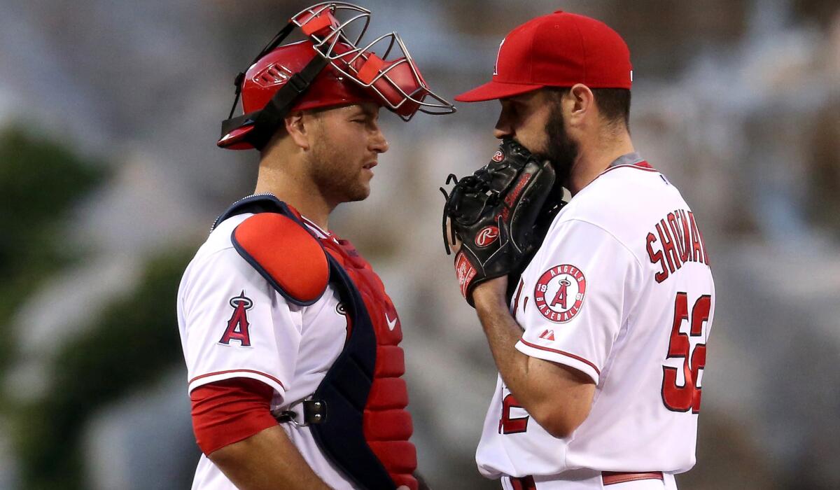 Angels catcher Chris Iannetta talks to pitcher Matt Shoemaker during a game against the A's on April 20.