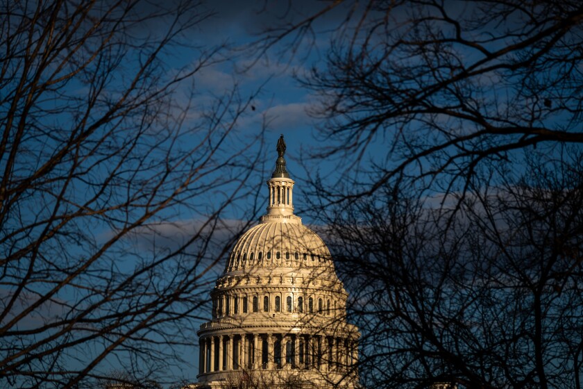 The dome of the U.S. Capitol building framed by bare trees in Monday's afternoon light.