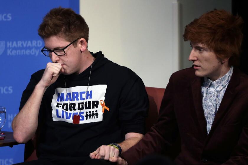 Marjory Stoneman Douglas High School students Matt Deitsch, left, Ryan Deitsch, right, participate a panel discussion about guns, Tuesday, March 20, 2018, at Harvard Kennedy School's Institute of Politics, in Cambridge, Mass. The Feb. 14, 2018 attack in Florida killed 17 people, 14 of them students. The students have become vocal advocates for stricter gun laws. (AP Photo/Steven Senne)