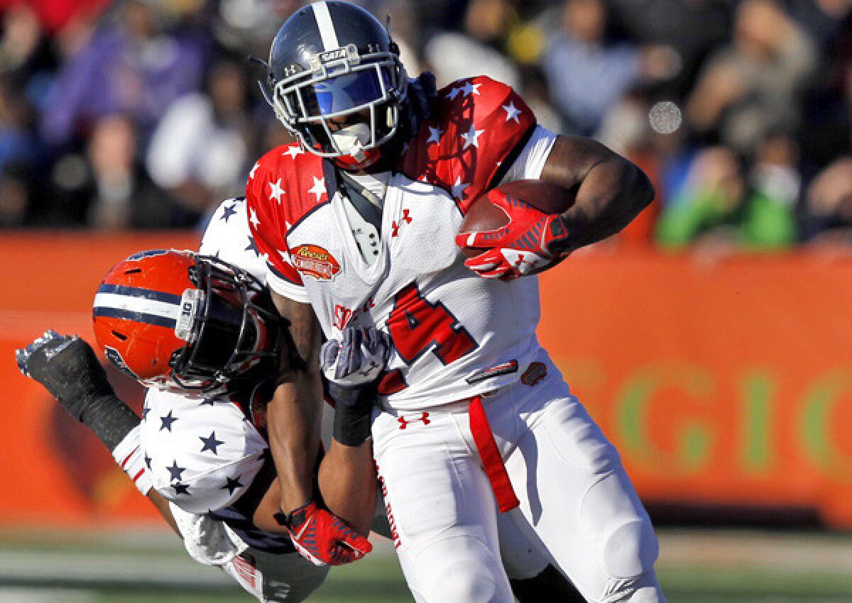 South running back Jerick McKinnon of Georgia Southern is tackled by Jonathan Brown of Illinois during the first half of the Senior Bowl on Saturday.