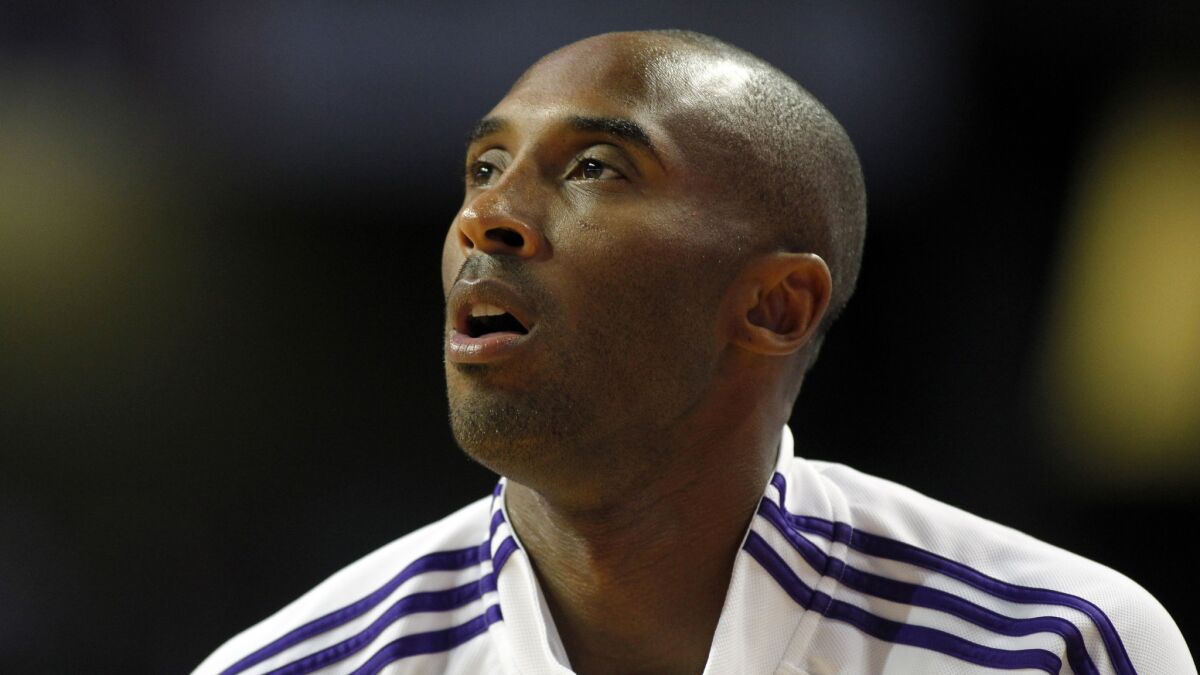 Lakers star Kobe Bryant warms up before Sunday's preseason loss to the Golden State Warriors.