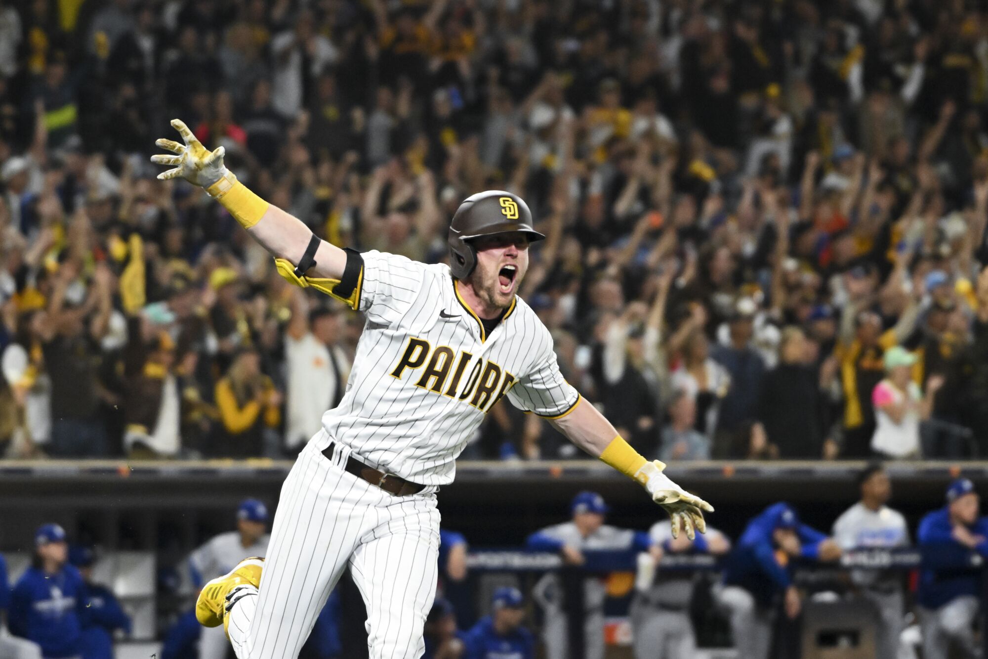 Padres Jake Cronenworth celebrates after hitting the go-ahead two-run double.