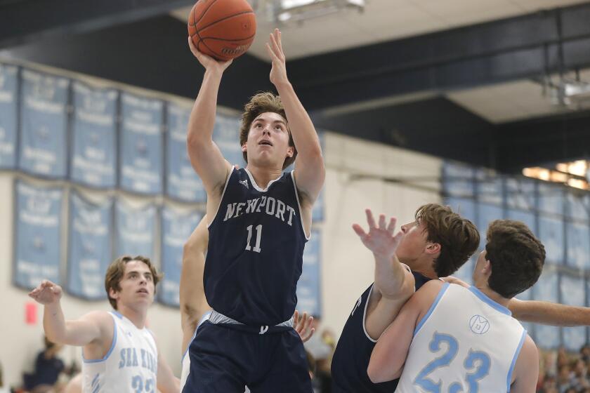 Newport Harbor's Levi Darrow makes a lay-up during Battle of the Bay basketball game against Corona Del Mar on Friday.