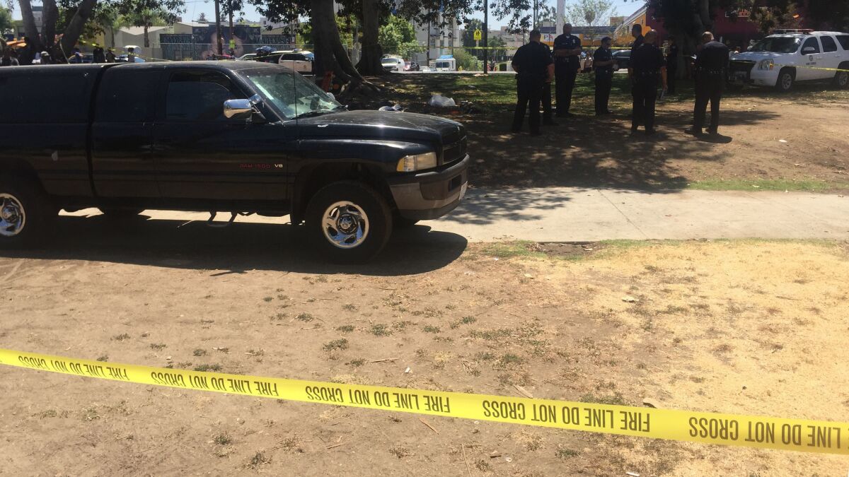 Police investigate the crash in MacArthur Park.