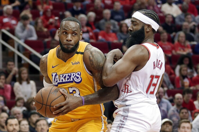 Lakers forward LeBron James drives to the basket against Rockets guard James Harden during the first half of a game Jan. 18, 2020, in Houston.