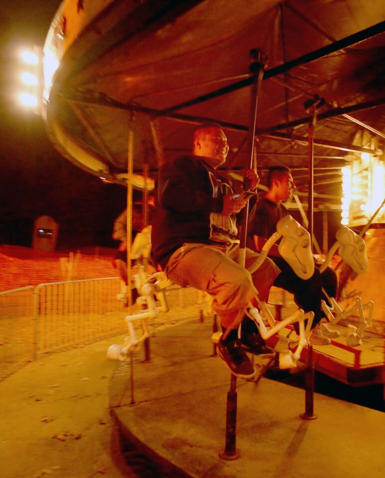 Guests ride the creepy carousel at the Haunted Hayride.