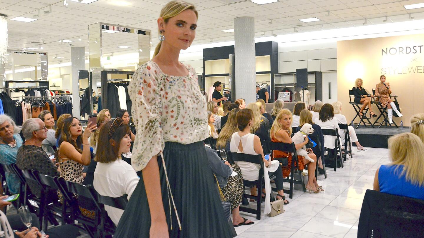 A model wears a top by Joie and a skirt by 1. State on Thursday during StyleWeekOC at Fashion Island.