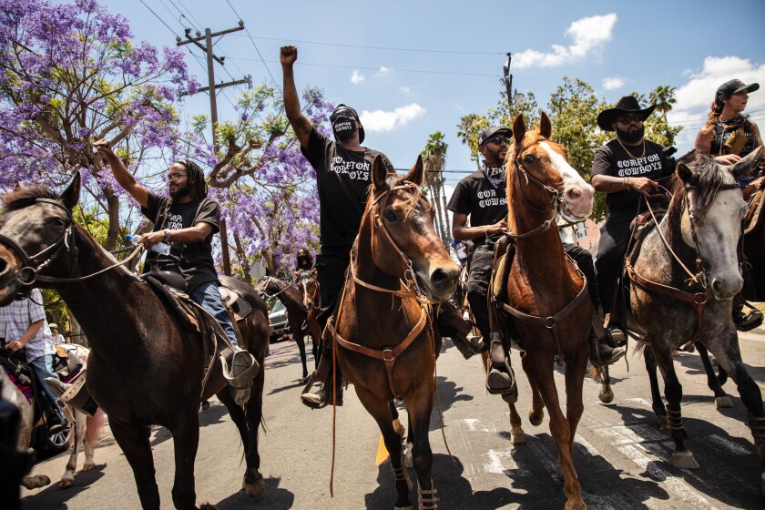The Compton Cowboys joined protesters Sunday on South Tamarind Avenue in Compton.