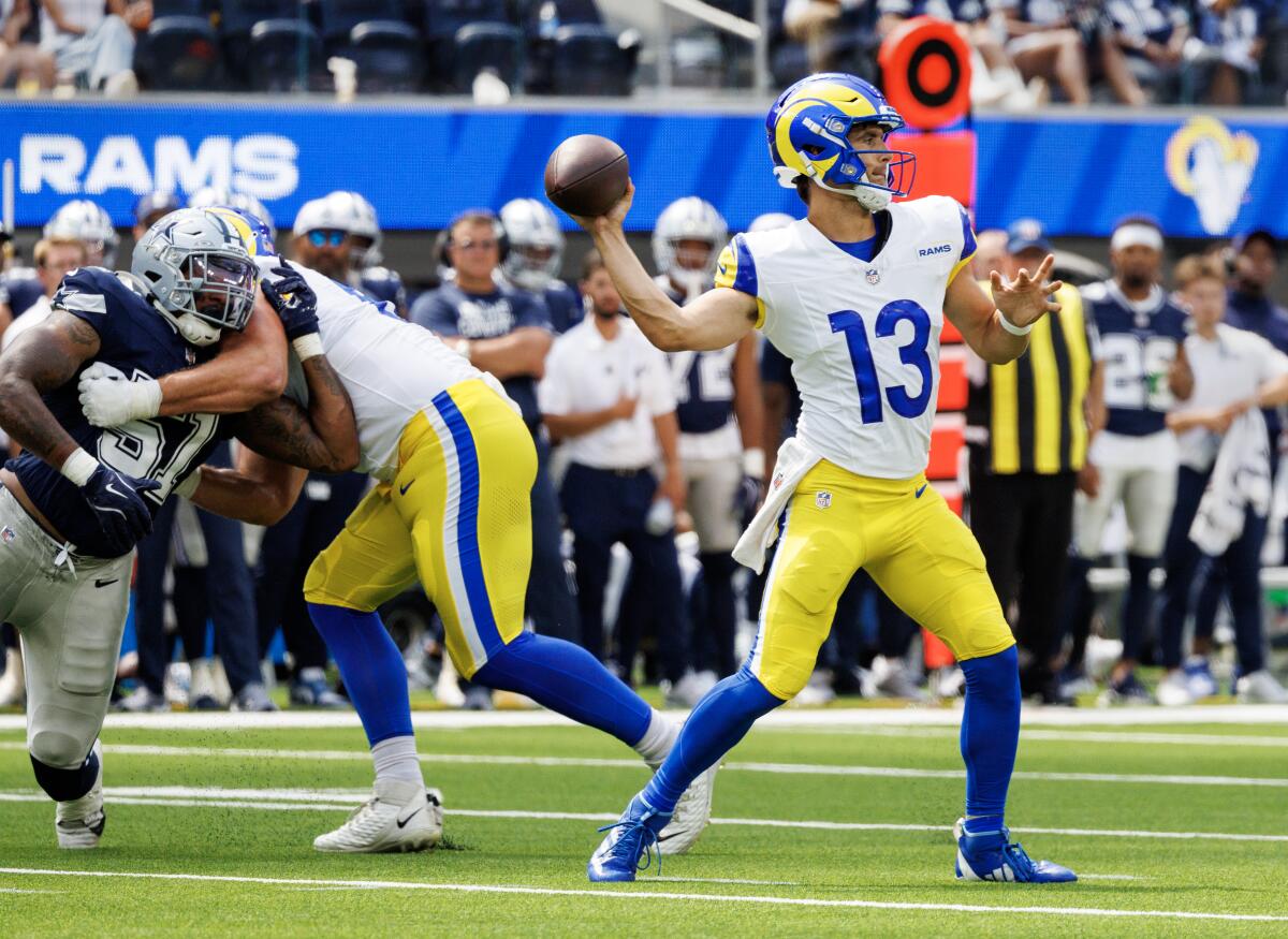 Stetson Bennett looks for an open receiver against the Dallas Cowboys in the first half.