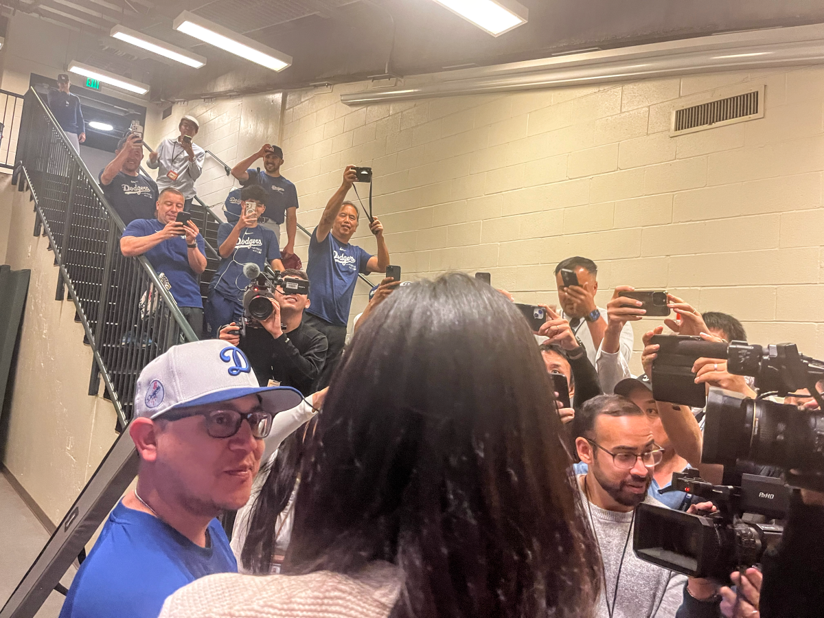 Dodgers bat boy Javier Herrera, left, is interviewed before a game between the Dodgers and San Francisco Giants.