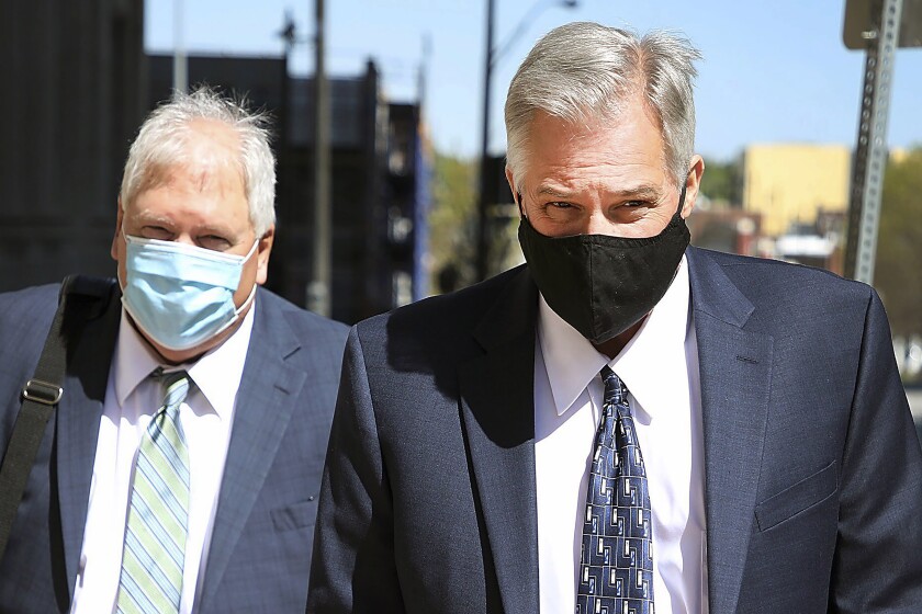 FILE - Former Tulsa Police Officer Shannon Kepler, right, leaves court at the Tulsa Federal Building during his fifth trial in the killing of his daughter's boyfriend Jeremey Lake Monday, April 19, 2021 in Tulsa, Okla. Kepler, convicted of second-degree murder in the fatal shooting of Lake, has been sentenced to 25 years in federal prison by U.S. District Judge Gregory Frizzell on Friday, Jan. 7, 2022. (Mike Simons/Tulsa World via AP, File)