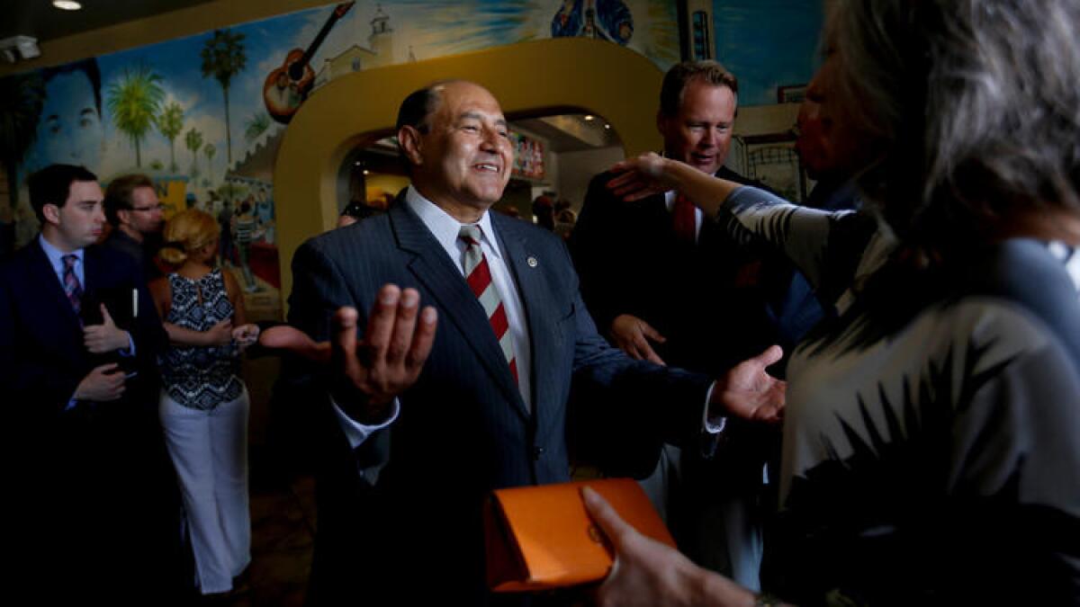 Lou Correa, who is running for Loretta Sanchez's congressional seat in the 46th district, greets supporters at a campaign fundraiser at the La Casa Garcia restaurant in Anaheim.