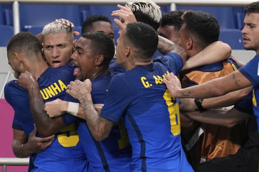 Brazil's Richarlison, second left, is congratulated by his teammates after scored his side's 2nd goal against Saudi Arabia during a men's soccer match against Saudi Arabia at the 2020 Summer Olympics, Wednesday, July 28, 2021, in Saitama, Japan. (AP Photo/Martin Mejia)