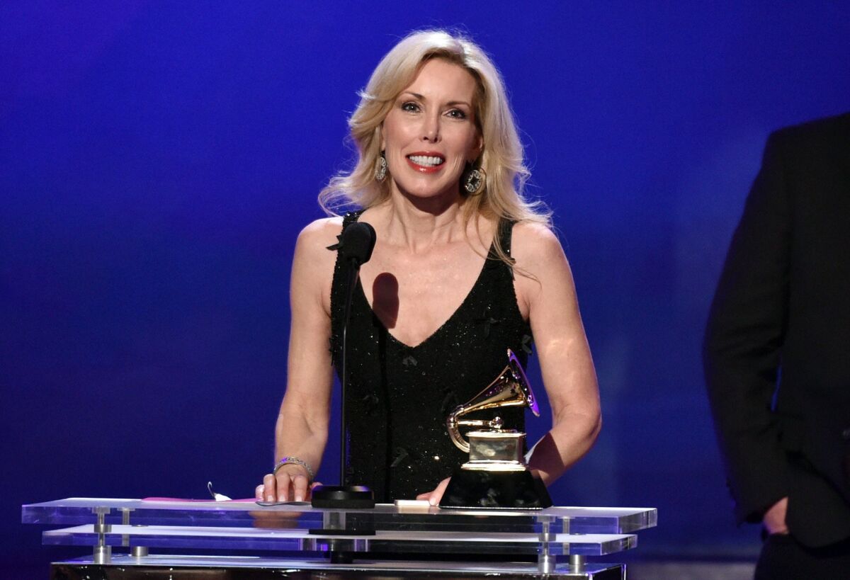 Kimberly Campbell accepts the award for best country song for "I'm Not Gonna Miss You" on behalf of her husband, Glen Campbell, at the Grammy Awards on Sunday.
