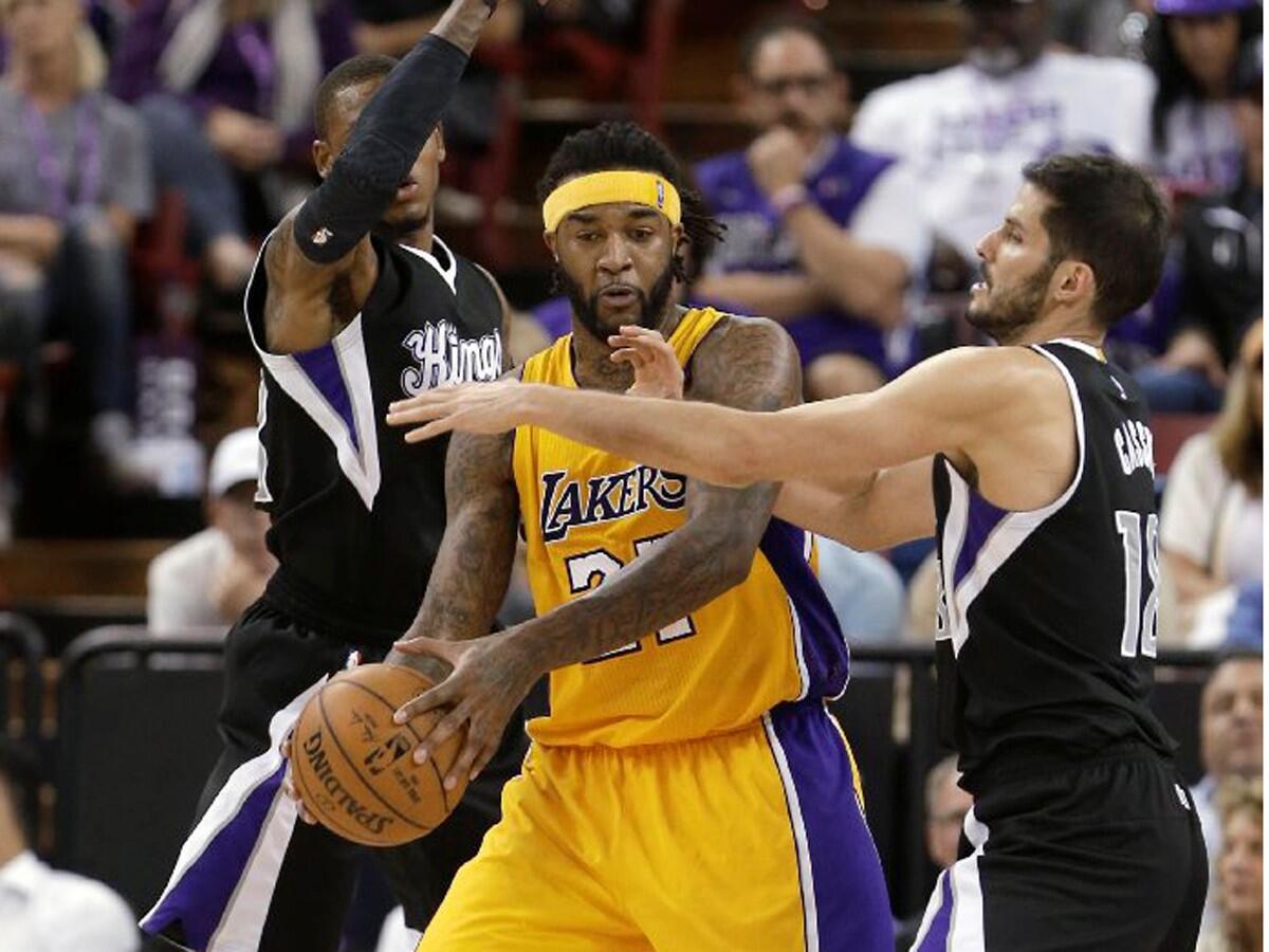 Kings guard Ben McLemore and forward Omri Casspi double team Lakers power forward Jordan Hill during the second half.