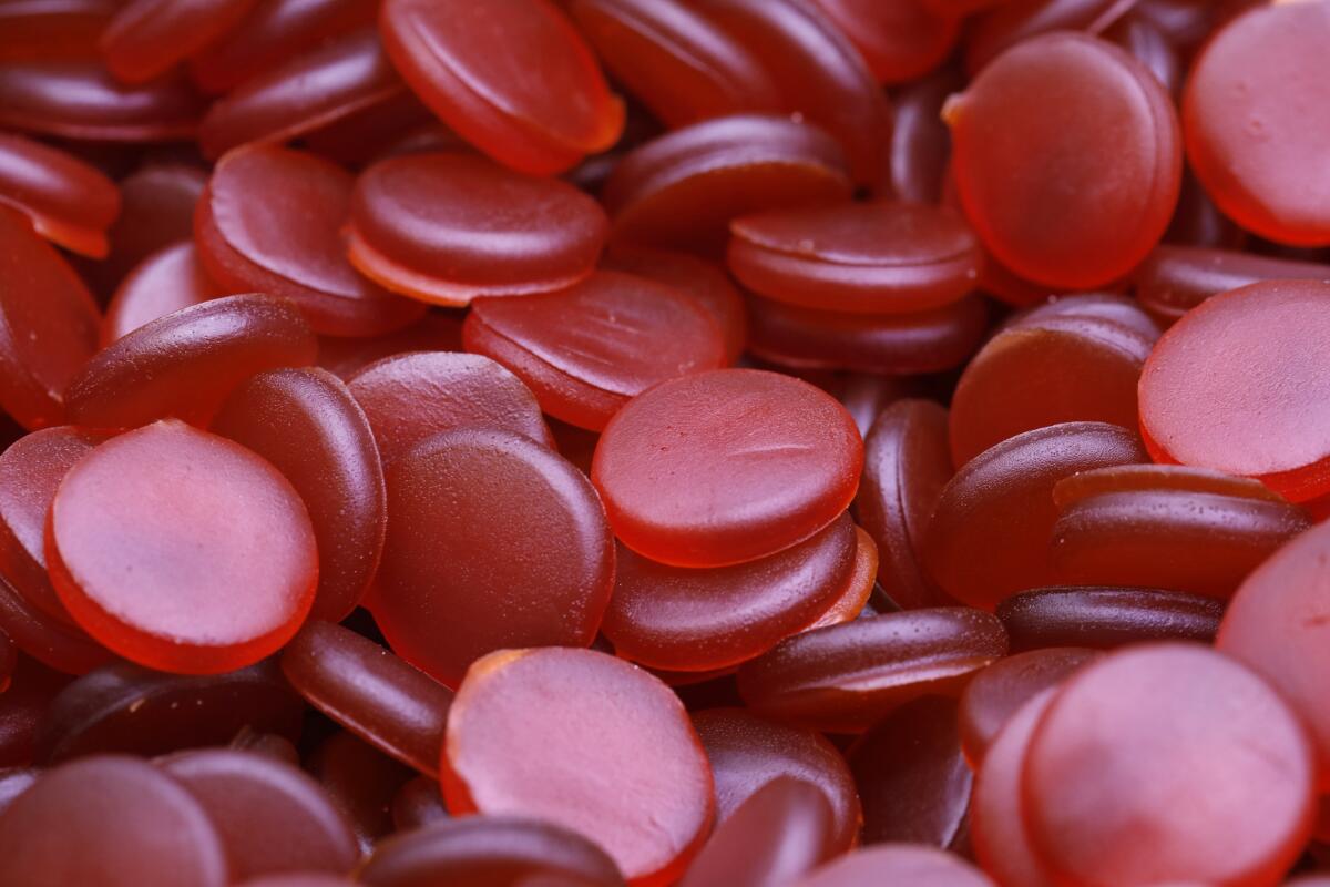 Entire frame filled with red, round marijuana gummies.