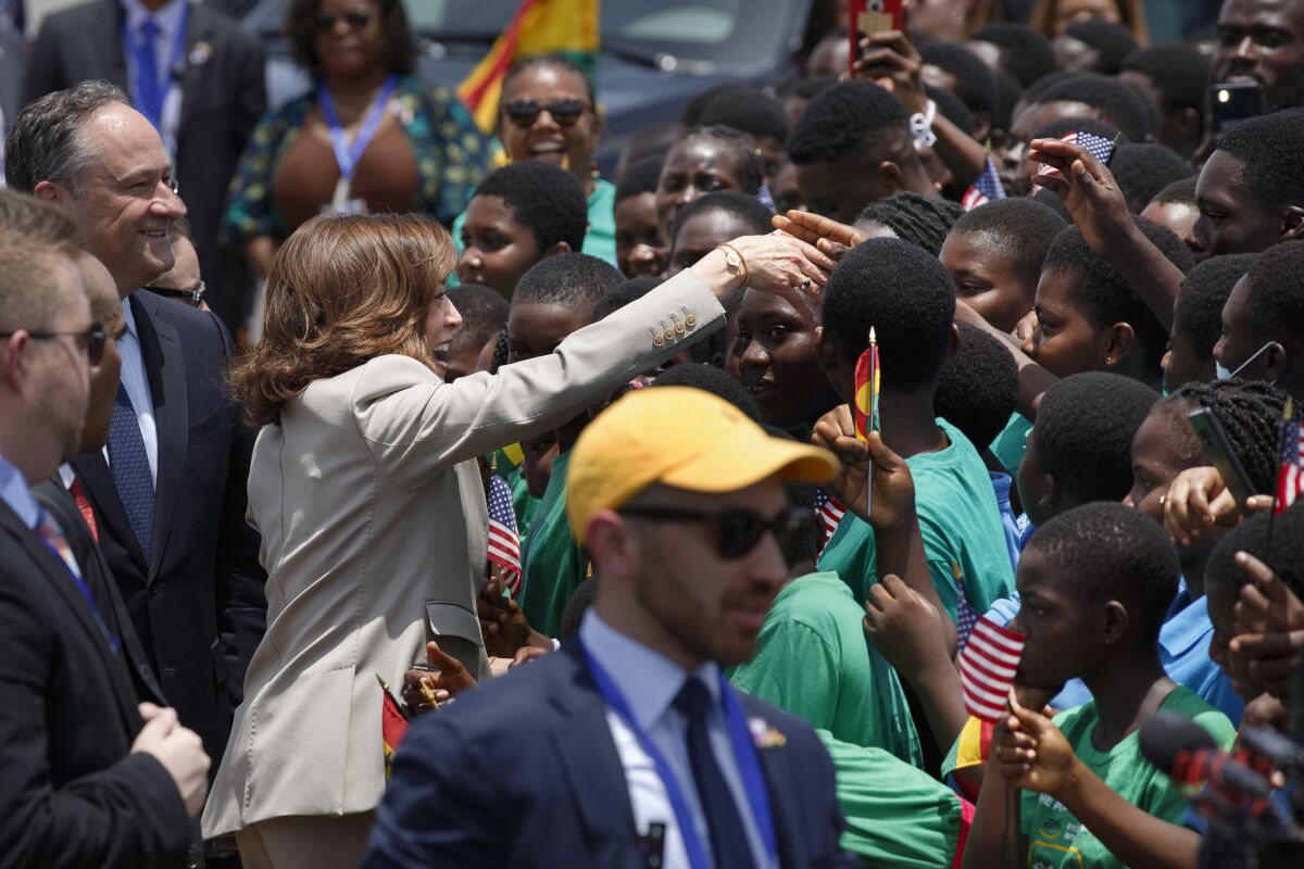 U.S. Vice President Kamala Harris greets school children during her arrival ceremony at Kotoka International Airport in Accra, Ghana Sunday, March 26, 2023. Harris is on a seven-day African visit that will also take her to Tanzania and Zambia. (AP Photo/Misper Apawu)