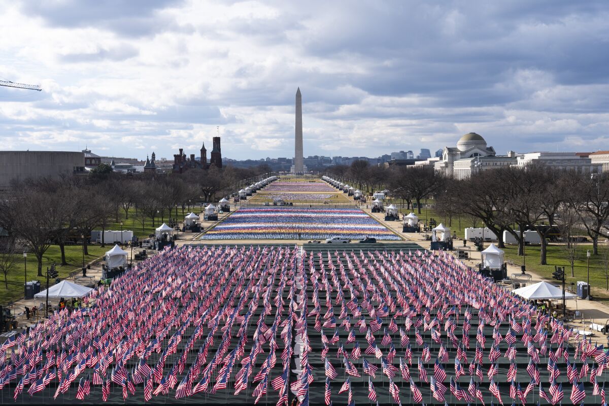 Flags are placed on the National Mall, looking toward the Washington Monument