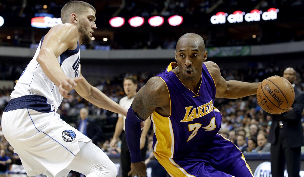 Lakers guard Kobe Bryant tries to drive past Mavericks forward Chandler Parsons in the first half Friday night in Dallas.