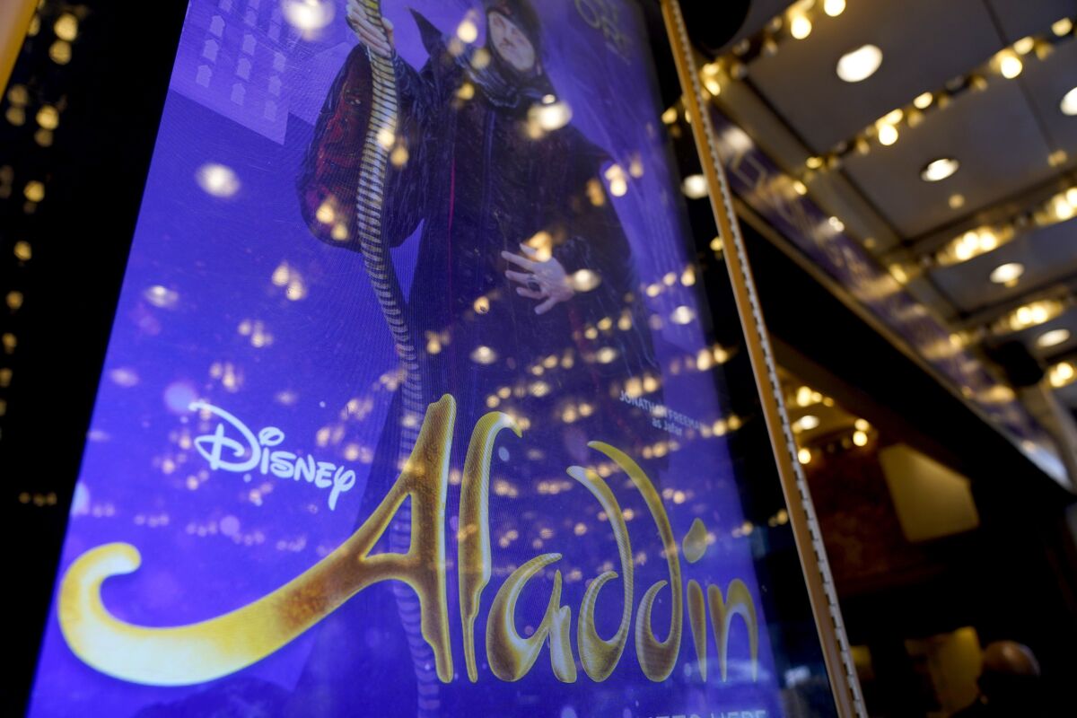 A sign advertising the show "Aladdin" is displayed in front of the New Amsterdam theater in New York, Thursday, Sept. 30, 2021. The hit Broadway show was canceled Wednesday night when breakthrough COVID-19 cases were reported within the musical's company, a day after the show reopened, a worrying sign for Broadway. (AP Photo/Seth Wenig)