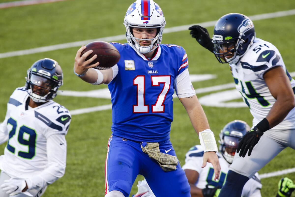 Buffalo Bills quarterback Josh Allen (17) rushes past Seattle Seahawks' Bruce Irvin (51) and Jayson Stanley (29) for a touchdown during the second half of an NFL football game Sunday, Nov. 8, 2020, in Orchard Park, N.Y. (AP Photo/Jeffrey T. Barnes)