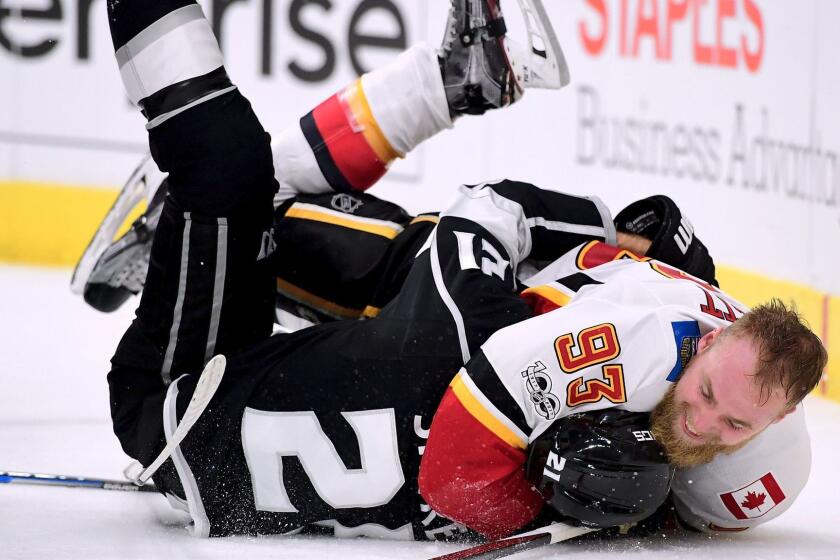 LOS ANGELES, CA - OCTOBER 11: Sam Bennett #93 of the Calgary Flames wrestles Nick Shore #21 of the Los Angeles Kings to the ground during the third period in a 4-3 overtime Flames win at Staples Center on October 11, 2017 in Los Angeles, California. (Photo by Harry How/Getty Images) ** OUTS - ELSENT, FPG, CM - OUTS * NM, PH, VA if sourced by CT, LA or MoD **