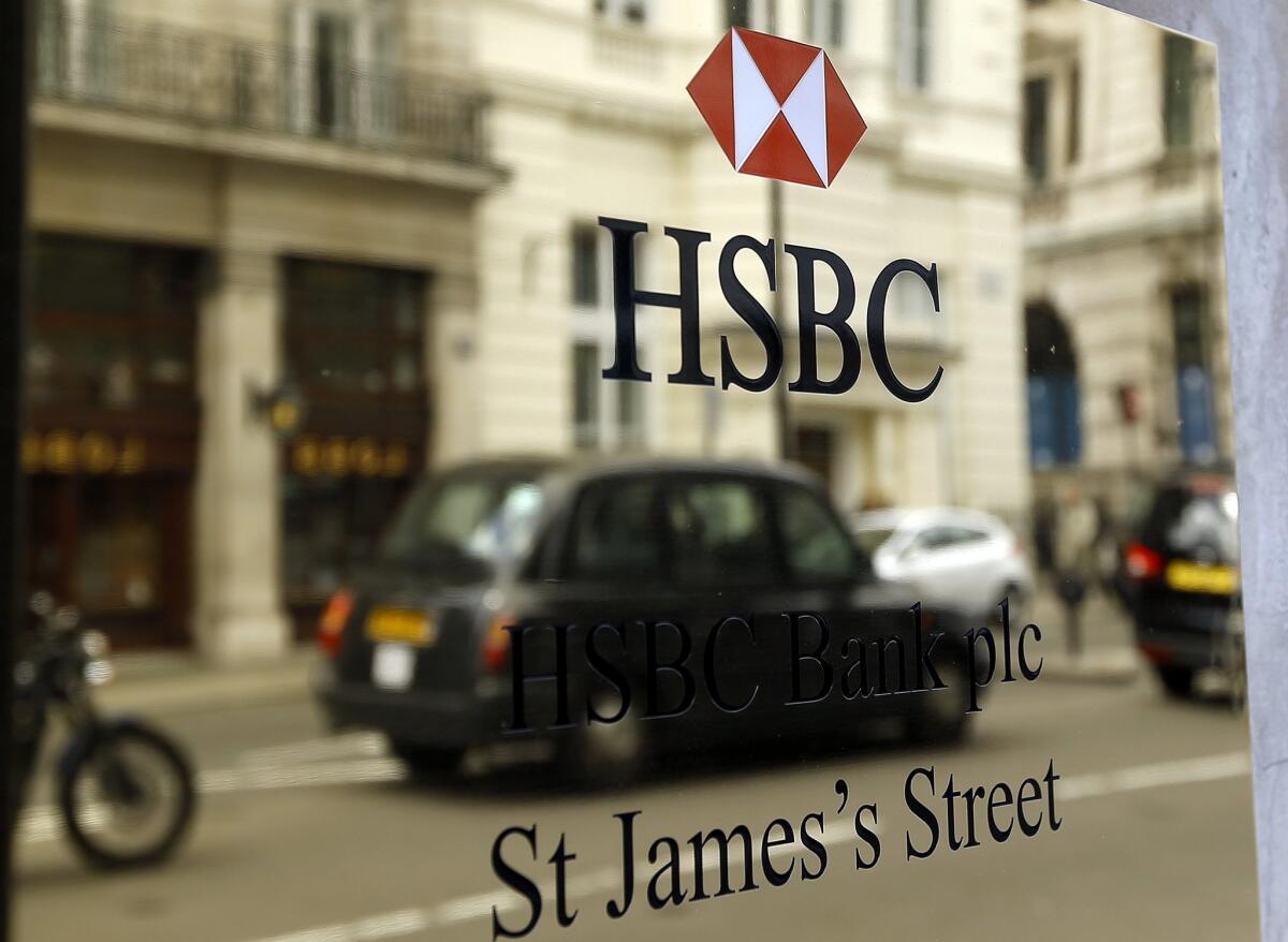 A taxi drives past an HSBC plaque in London on June 9.