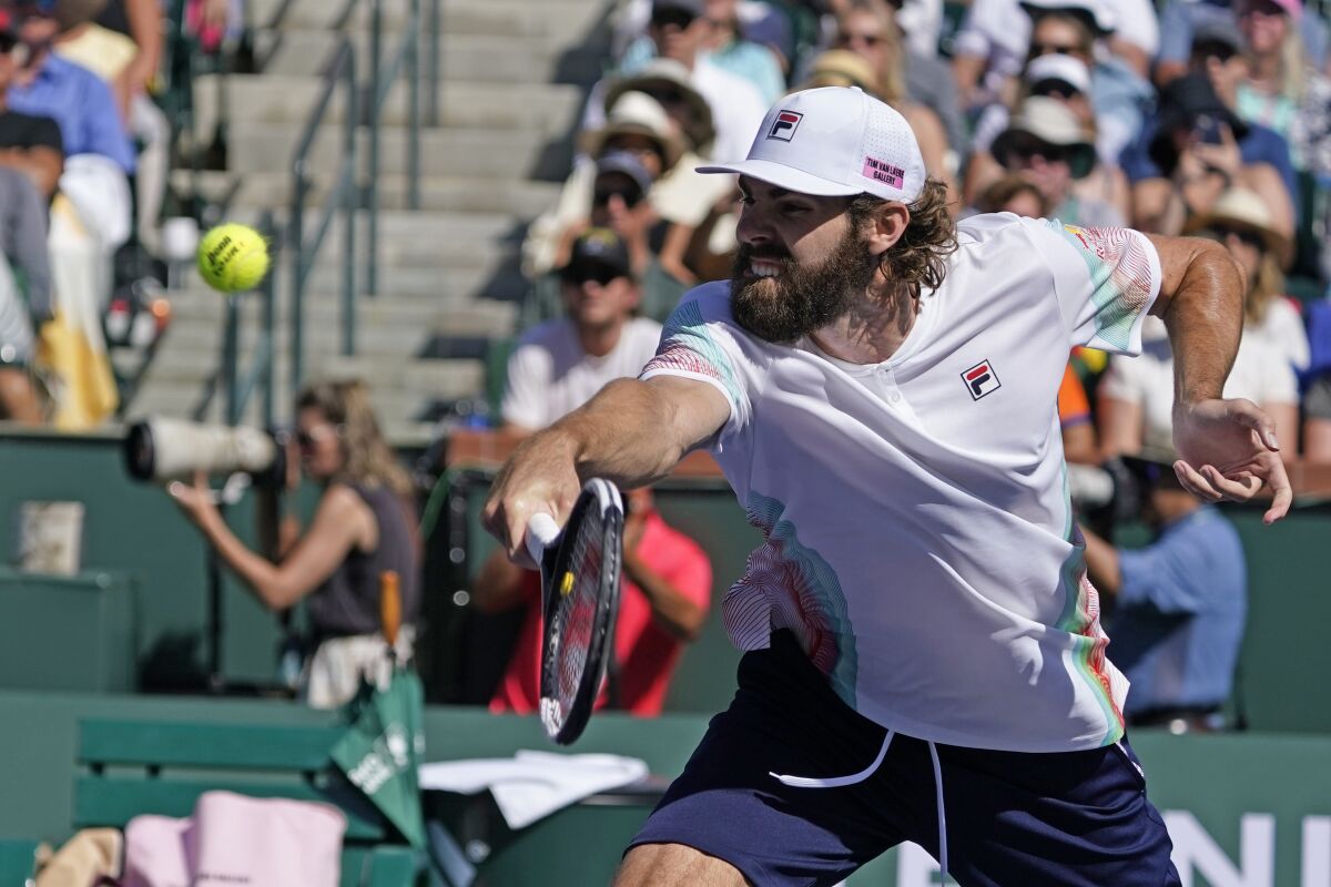 Reilly Opelka returns to Rafael Nadal, of Spain, at the BNP Paribas Open tennis tournament Wednesday, March 16, 2022, in Indian Wells, Calif. (AP Photo/Marcio Jose Sanchez)