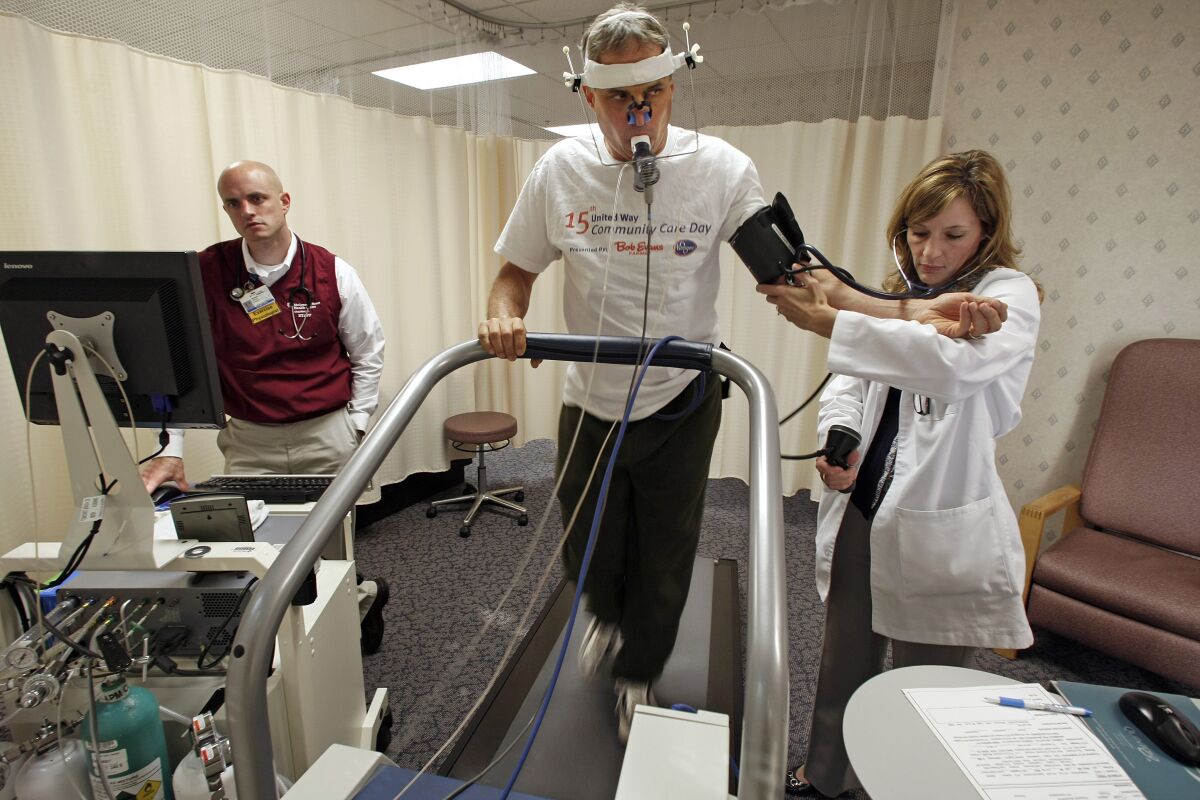 Exercise physiologist Jesse Hickerson, left, and nurse Deborah Kuntz keep track of David Brookfield's vitals 